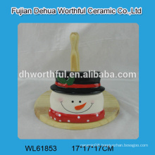 Ceramic tissue holder in snowman shape with wooden part